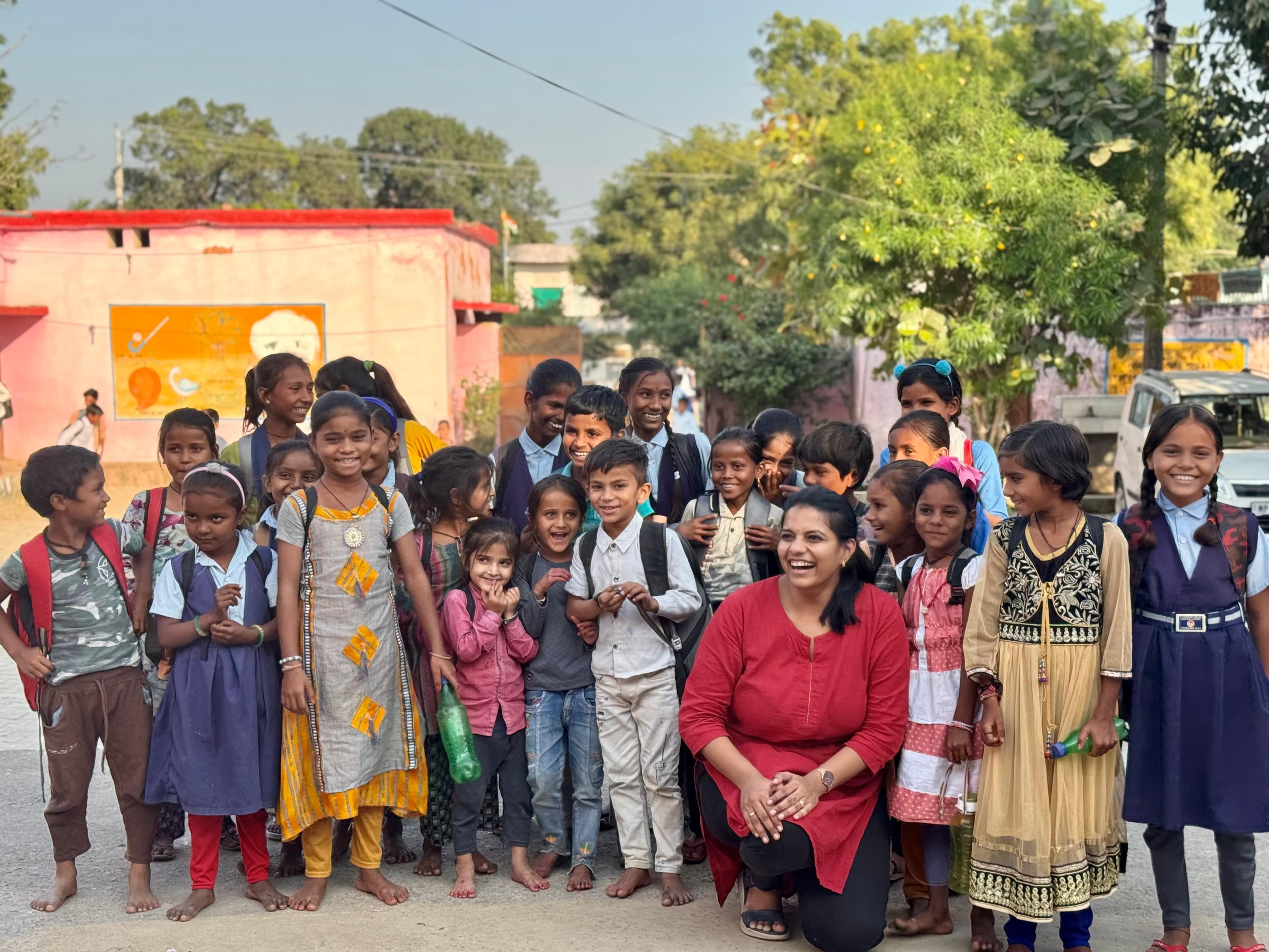 Rural woman teaching children - Education Starts With Her